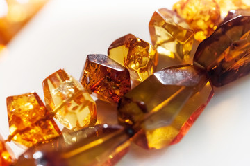 Macro photo of amber beads on white background