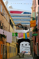typical Venice calle with passenger ship in the background