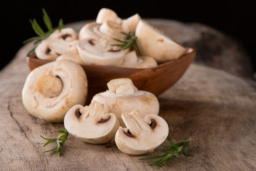Fresh champignon mushrooms on wood 