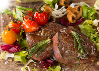 Grilled steaks on wood 