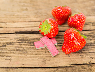 Strawberry chewing gum on wooden background