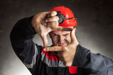 Coal miner looking through a finger frame