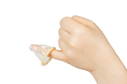female hand holding condom on finger