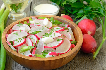 Radish salad in wooden bowl
