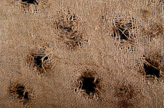 Torn burlap decayed. Ragged linen fabric.