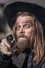 Cowboy Points Gun at Camera