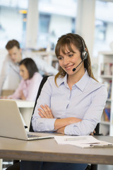 Cheerful Businesswoman in the office on the phone, headset