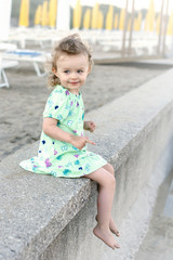 Little girl sitting on the beach