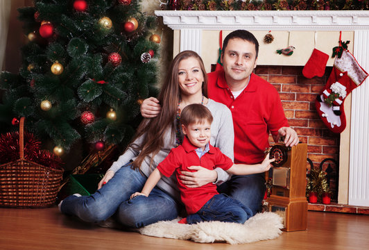 Happy family in Front Of Christmas Tree