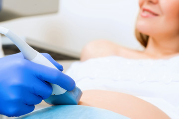 Obraz na płótnie Canvas close-up of hands and abdominal ultrasound scanner