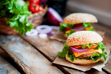 Closeup of home made burgers on wooden background