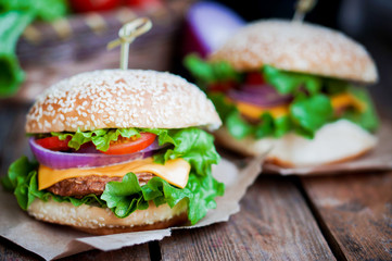 Closeup of home made burgers on wooden background