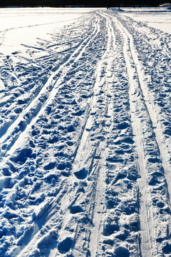 ski runs in snowy field in winter day