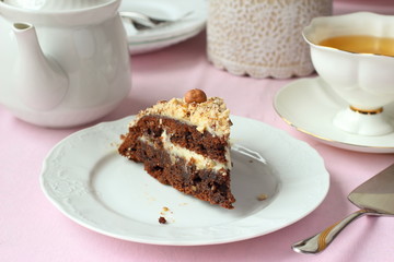 Piece of Chocolate cake with nuts and tea