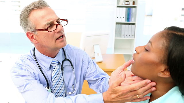 Doctor checking neck glands of his patient