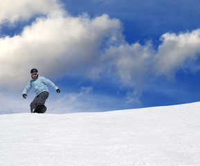 Fototapeta na wymiar Snowboarder on ski slope at nice day