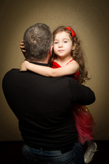 Fototapeta premium Girl on the hands of the dad and hugs him
