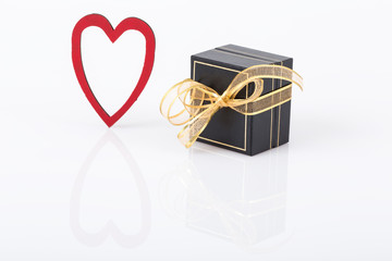 gift and heart on white