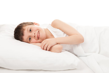 cheerful boy in white bed