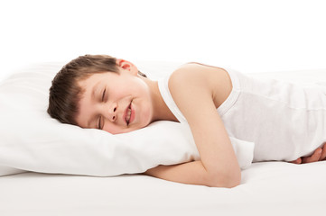 cheerful boy in white bed