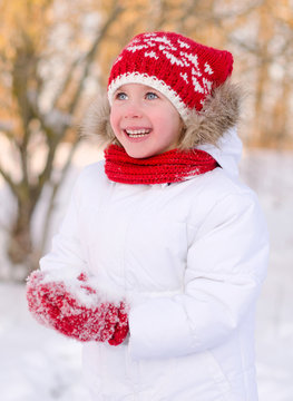 Pretty smiling little girl in wintertime.