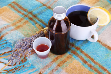 Cough syrup on knitted scarf close-up