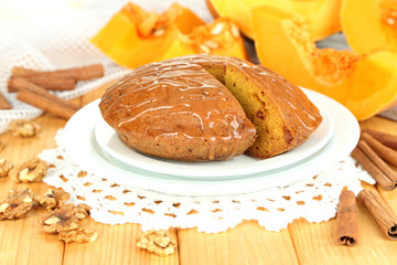 Delicious pumpkin pie on plate on wooden table close-up