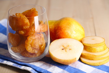 Dried pears on wooden background