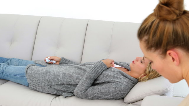Upset blonde woman lying on couch explaining her problems