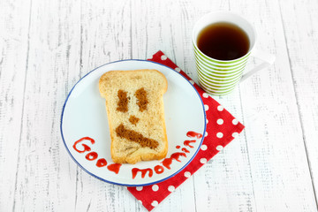 Funny toast, on color wooden background