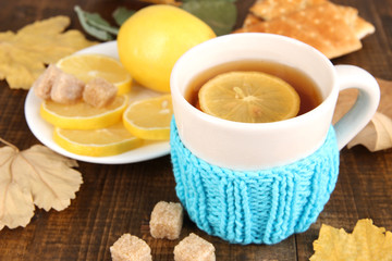Cup of tea with lemon on wooden table