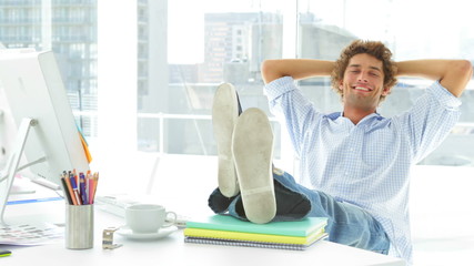 Relaxed businessman reclining on his swivel chair