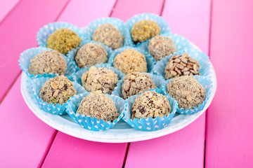 Set of chocolate candies, on wooden background