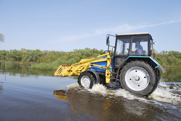 tractor across the river which came out of its banks and flooded