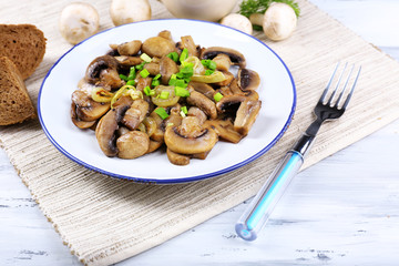 Delicious fried mushrooms on plate on table close-up