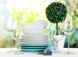 Clean dishes on table on natural background