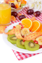 Sweet fresh fruits on plate on table close-up