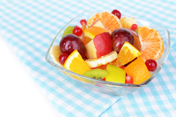 Sweet fresh fruits in bowl on table close-up