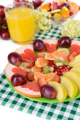 Sweet fresh fruits on plate on table close-up