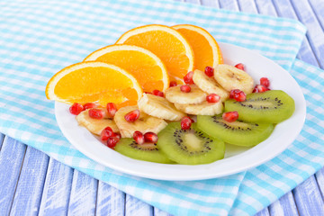 Sweet fresh fruits on plate on table close-up