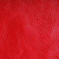 Red textured leather grunge background closeup