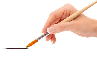 Female hand holding paint brush isolated
