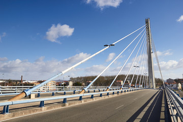 Fototapeta na wymiar suspension bridge against the blue sky
