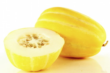 cut and whole yellow korean melon closeup