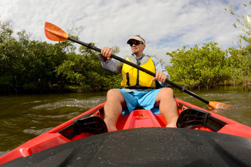 man in red kayak