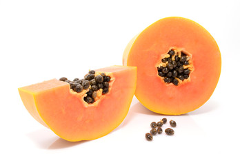Half cut and whole papaya fruits on white background