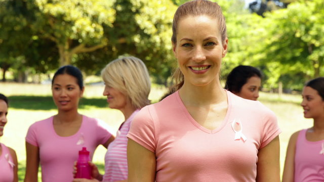 Activists for breast cancer awareness one smiling at camera