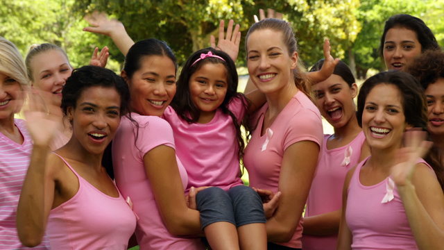 Happy women in pink for breast cancer awareness in the park
