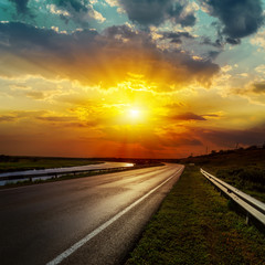 dramatic sunset over asphalt road