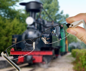 Man is viewing to vintage train on display